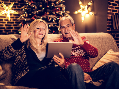 Lakeside-Living_Manitowish-Waters-WI_How-to-Show-Your-Loved-Ones-You-Care-This-Holiday-Season_Couple-on-iPad-Chatting-with-Family-at-Christmas-Time