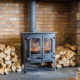 Manitowish Waters WI antique wood burning stove surrounded by stacks of wood