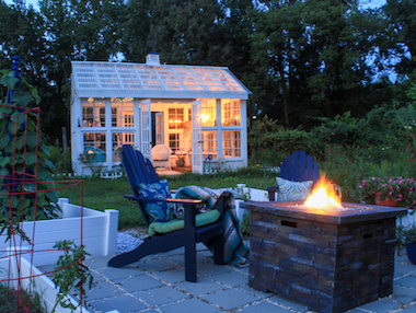  Lakeside-Living_Manitowish-Waters-Wisconsin_Northwoods-Interior-Design-outdoor-fire-table-selection-backyard-fire-table-adirondack-chairs-white-decorative-green-house