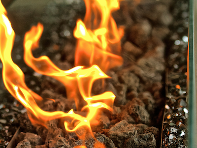 Lakeside-Living_Manitowish-Waters-Wisconsin_Northwoods-Interior-Design-outdoor-fire-table-selection-close-up-fire-on-fire-table-dark-jagged-rocks