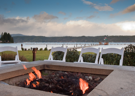 Lakeside-Living_Manitowish-Waters-Wisconsin_Northwoods-Interior-Design-outdoor-fire-table-selection-fire-table-on-a-lake-with-white-event-chairs