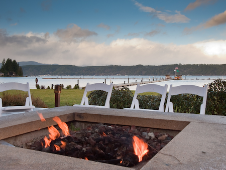 Lakeside-Living_Manitowish-Waters-Wisconsin_Northwoods-Interior-Design-outdoor-fire-table-selection-fire-table-on-a-lake-with-white-event-chairs